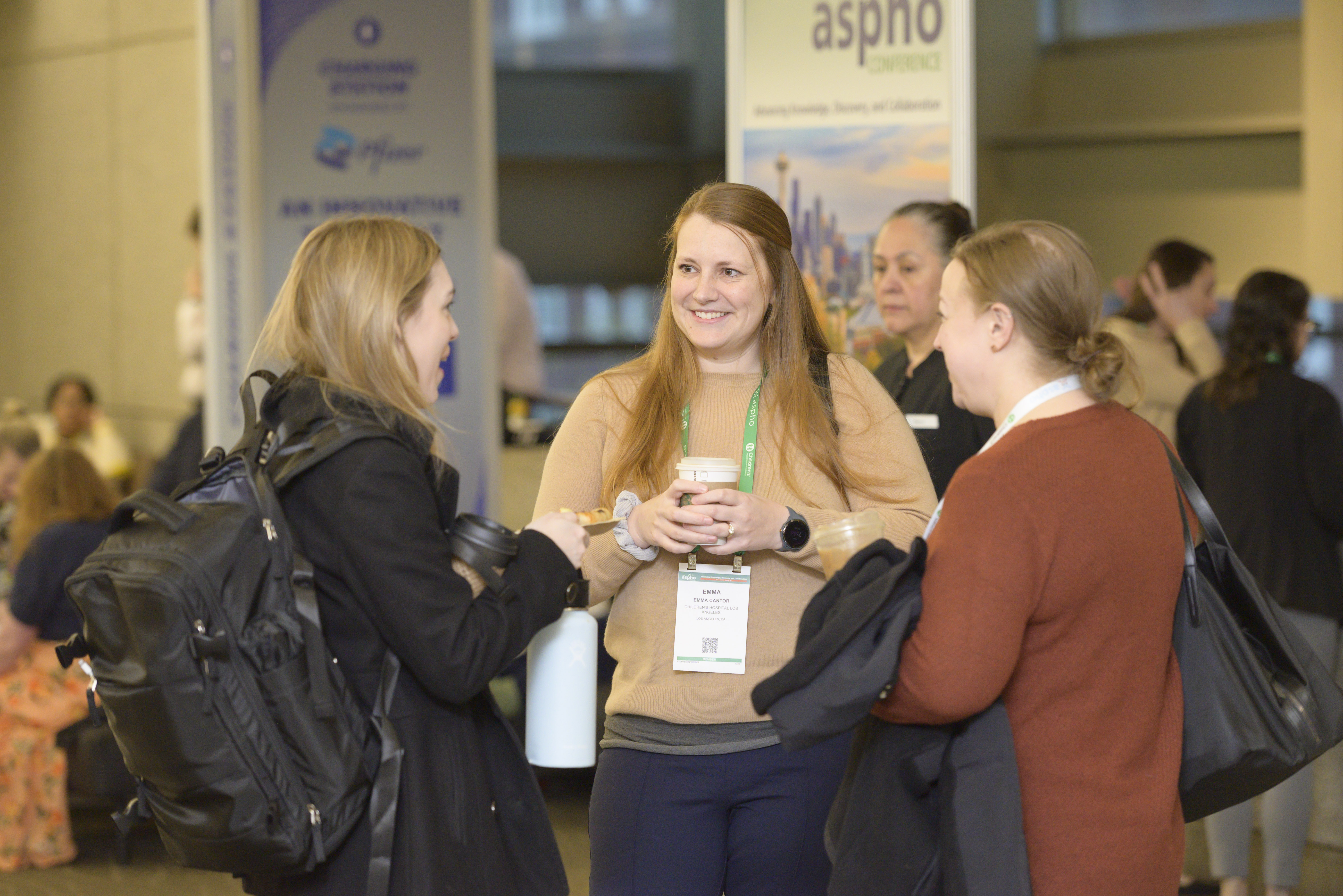 Three Conference Attendees Conversing